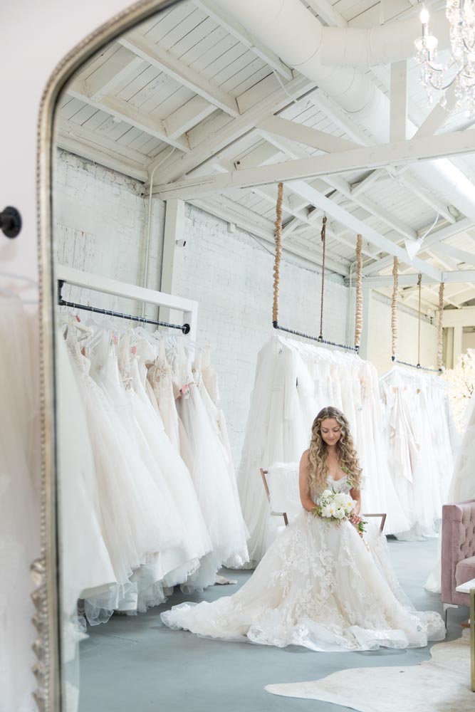 wedding dresses hanging from rods