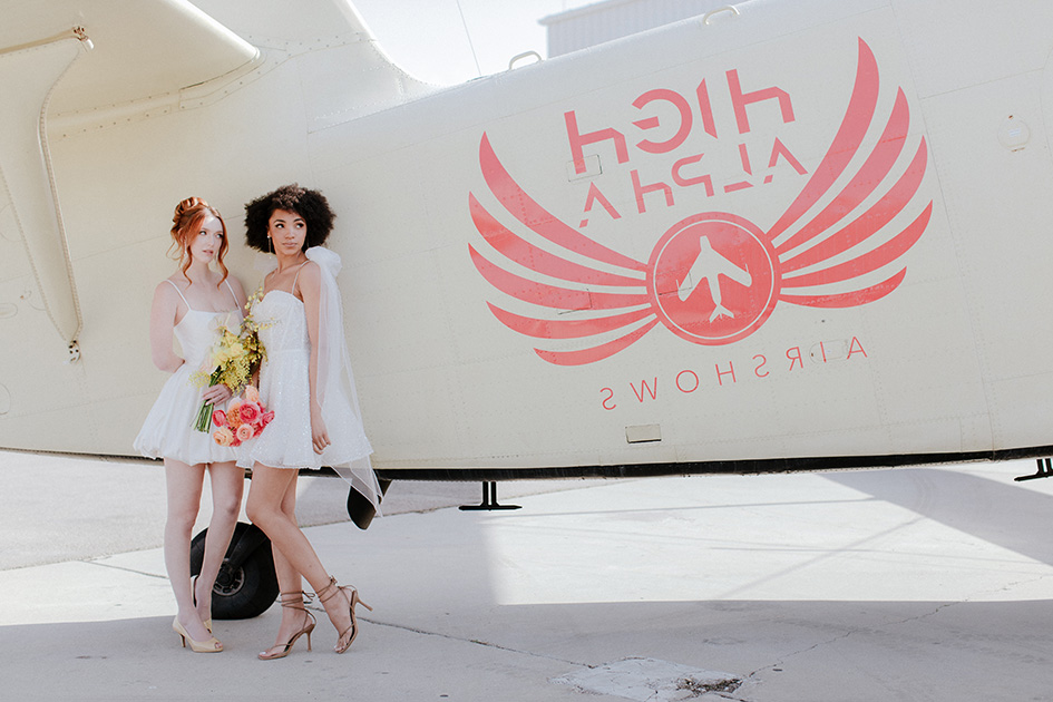 Brides standing by plane during event